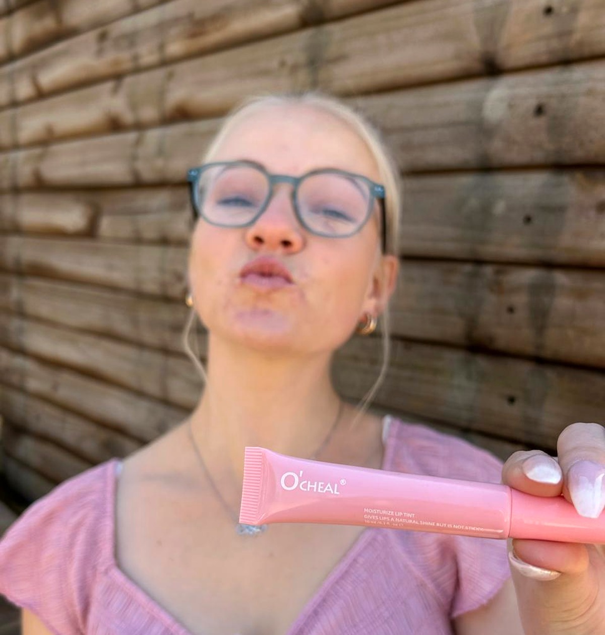 Woman with soft, glowing skin using Pretty as Pie skincare