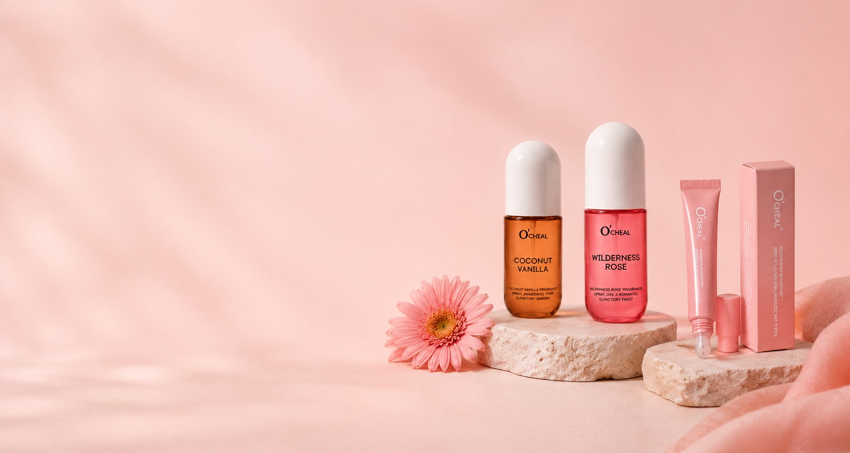 Wilderness Rose and Coconut Vanilla body mists with a lip gloss, displayed on stone pedestals